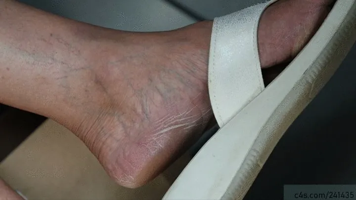 Candid dangling sandals, wrinkled nice mature feet moving continuously, foot fetish watching