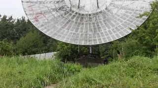 Naked girl on an old space communications station.
