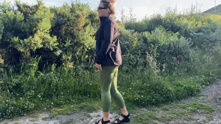 Girl in leggings peeing outdoor