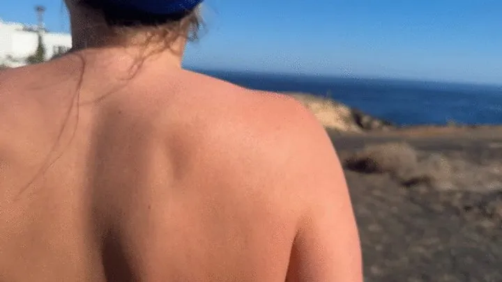 Girl is walking on the public beach and pee