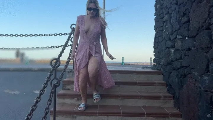 Blonde girl walking along the pier and flashing pussy tits