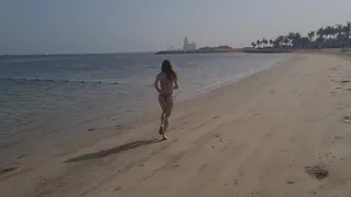 running and stretching on the beach