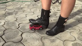 Crushed a toy car with black boots BD