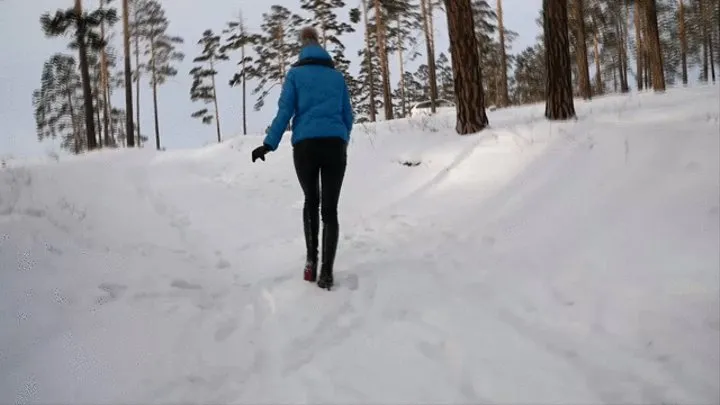 Long sexy legs in high heels walking in the snow and falling through it - Pretty girl storming up a snowy hill