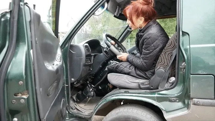 High-heeled beauty pedaling and driving a minibus car