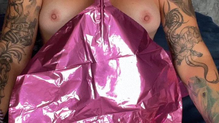 Girl with nacked tits blowing foil balloond