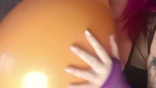 sexy in latex body with nacked tits blowing balloon