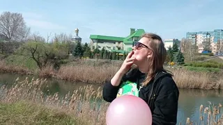 pop balloons in park with cigarette