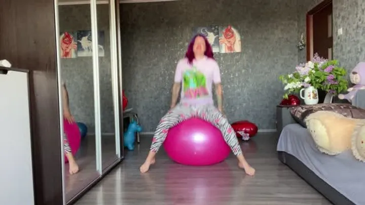 Girl jumping on pink yoga ball