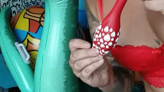 blowing red balloon on infatable and nailpop