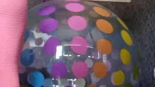 Jumping-on-giant-dottrd beachball