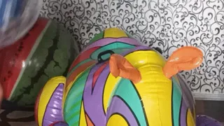 blowing big blue balloon on infatable