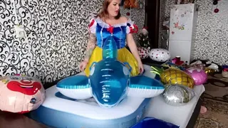 girl riding in pool and blue whale