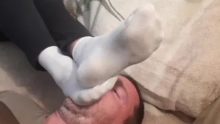 Face footstool in dirty socks and smelly feet