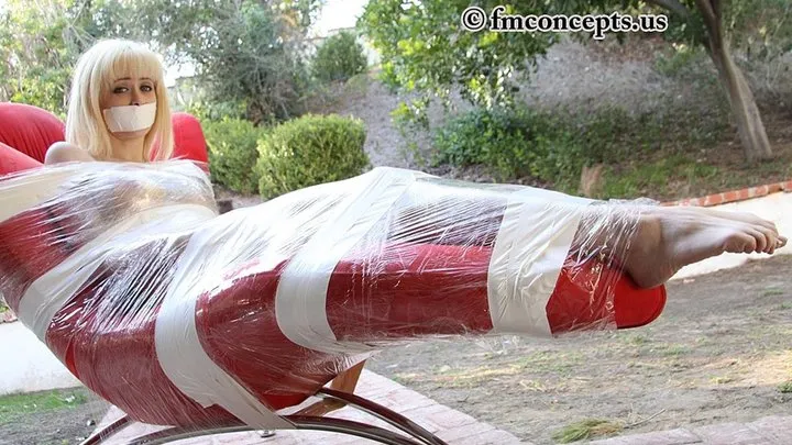 It Gets Hot Inside The Plastic Wrappings Emily Addison Is Restrained In As She Basks In The Sun!