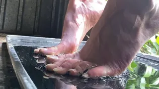 Bare feet stuck in sticky superglue trap