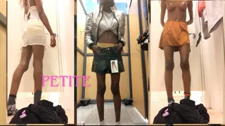 Skinny girl tries out different outfits in the dressing room