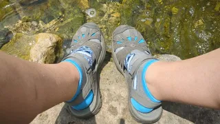 Fifi playing in the creek after yoga fully dressed in capri leggings and socks with sandals