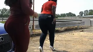Curvy black + white women in skintight red pants, blue jeans and on high heels