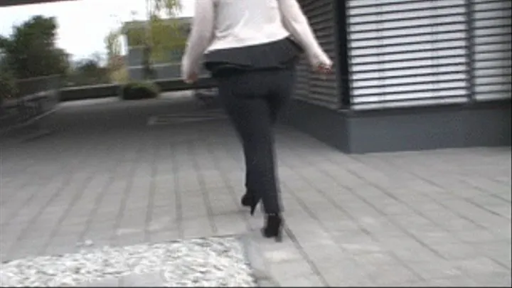 Big butt walking in skintight black stretch jeans and high heels