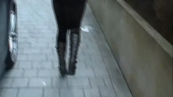 brunette latina is walking in skintight brown tark 1 stretch jeans on high heel boots