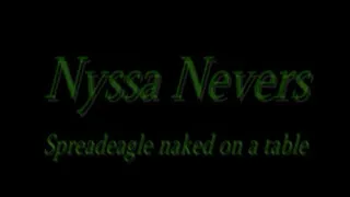 Nyssa Nevers spreadeagle across table