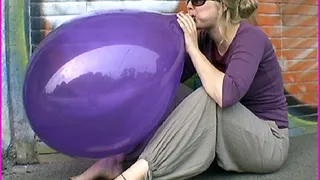 Larielle blows up a Balloon
