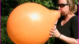 Lo blows up a Balloon in the Park