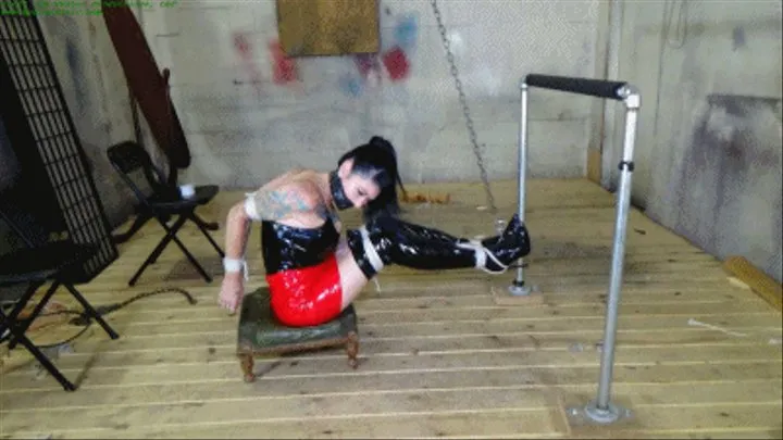 Busty captive hung by her boots with her bound swollen tits tethered to the pipes