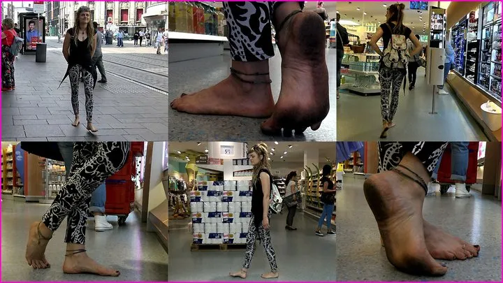 Barefoot dreadlocked Hippie Jennifer's filthy-black Soles in a Store