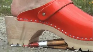 17 Crushing cigarettes with red clogs