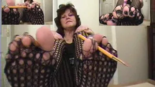 Terri snaps crayons and pencils with her dark fishnets