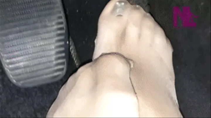 Closed up driving in nude toe-reinforced pantyhose