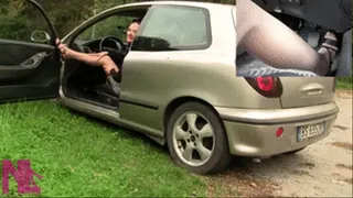 Revving and making car fume in sandals and nude pantyhose