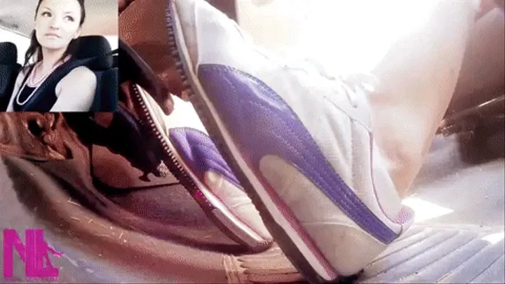 Driving in white purple Puma sneakers and white socks