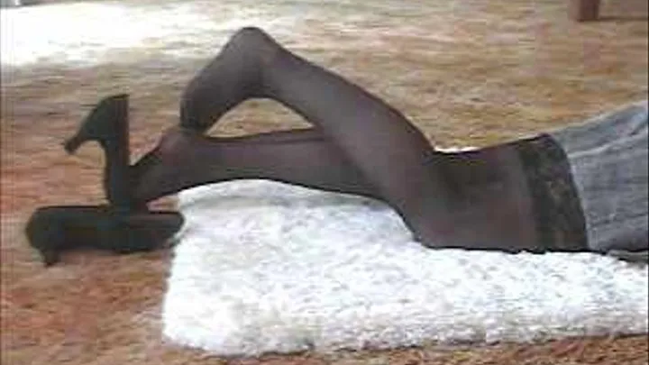 miss clareese lays on the floor wearing black nylon stockings