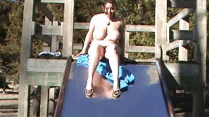 Bouncing huge boobs in a play park with a swing and slide