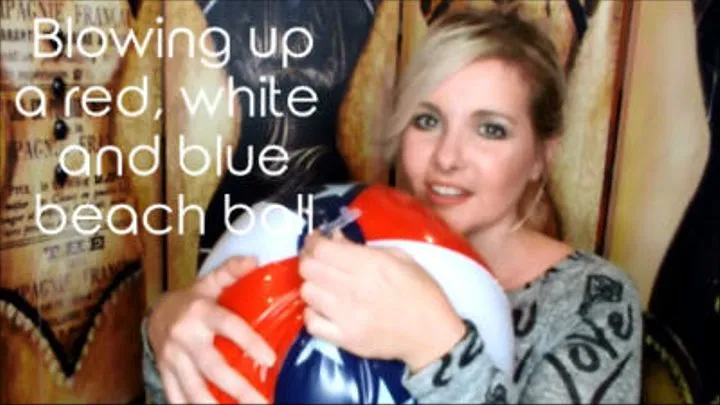 Blowing up a red, white and blue beach ball