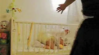 Big Baby Plays in the Cot