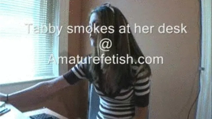 Tabby smokes at desk