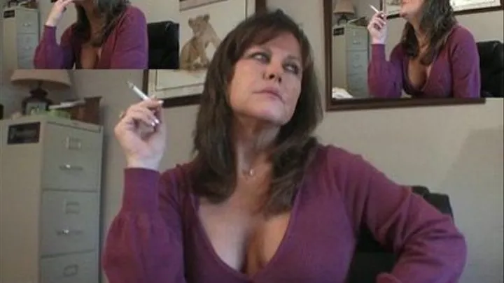 Terri smokes at her desk