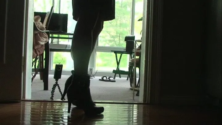 Lilly doing calf raises in the kitchen, silhouette view