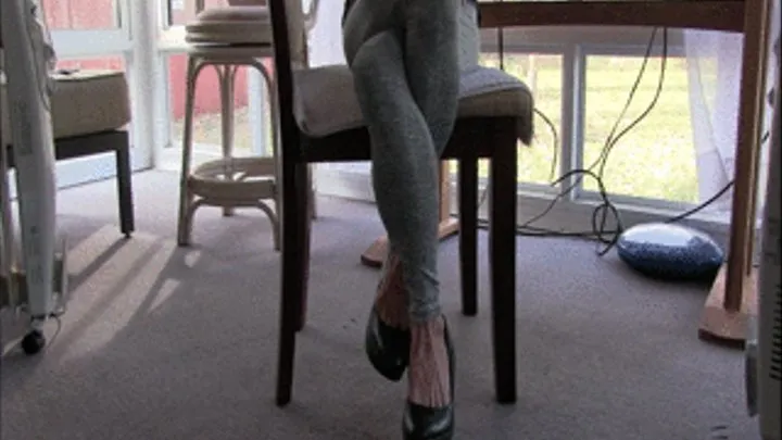 Lilly wearing yoga tights, double crossing her legs