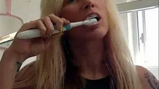 Liz brushes her teeth