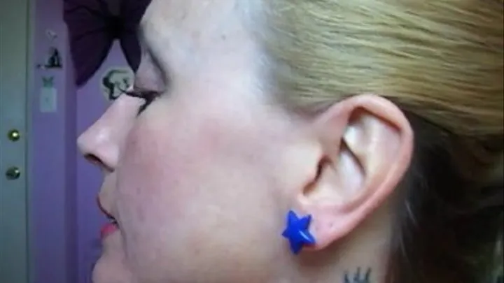 Close ups of Liz trying on ear rings and her ears