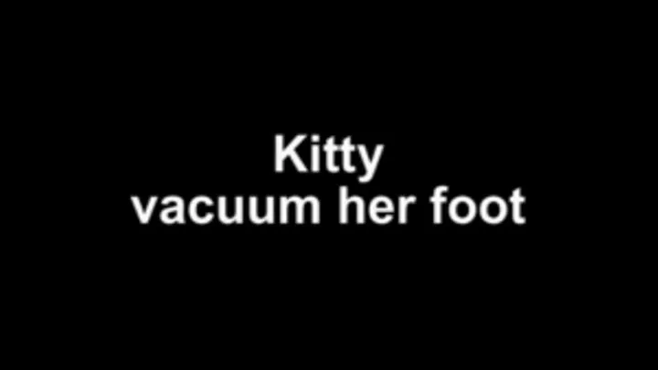 Kitty vacuum her foot