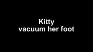 Kitty vacuum her foot