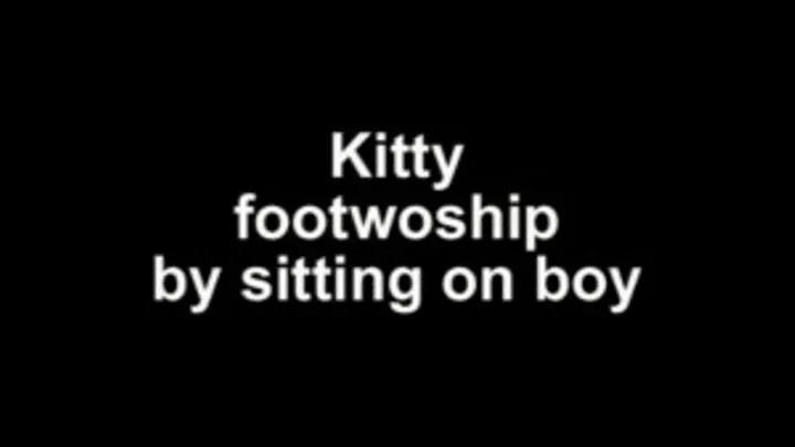 Kitty footworship by sitting on boy breast