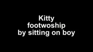 Kitty footworship by sitting on boy