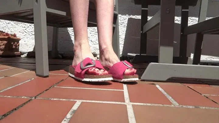 Shoe play, toe wiggling, wrinkled soles in the sun on the garden terrace